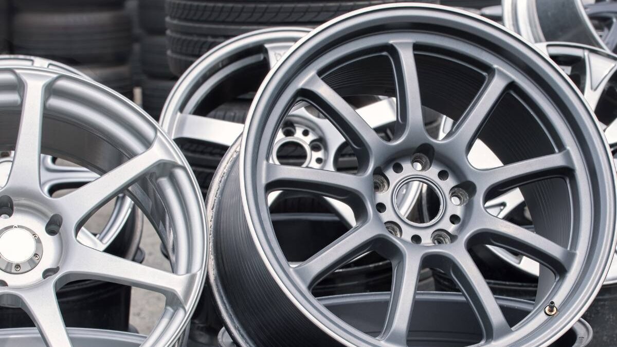 Close-up of high-performance car wheels with a metallic finish on display.
