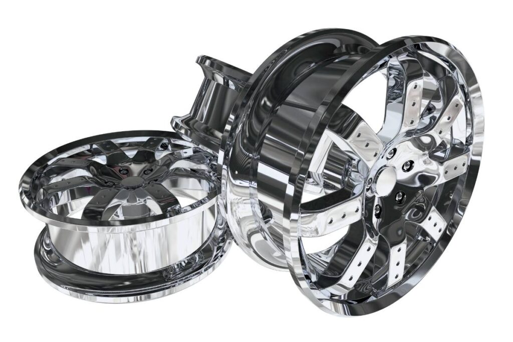 Shiny chrome car rims displayed against a white background.